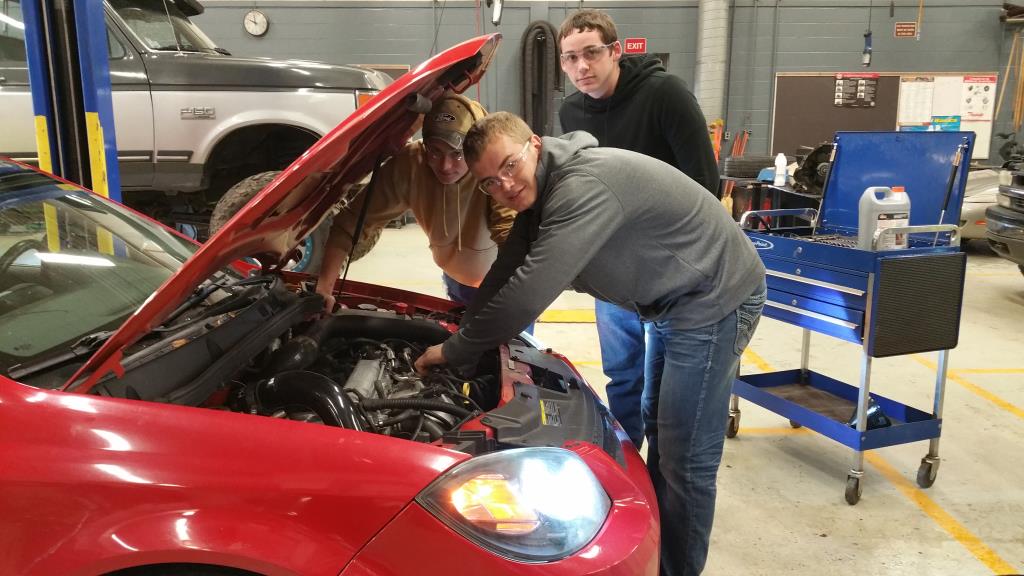 Students working on a car in auto class.