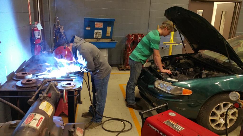 Students welding parts for a car.