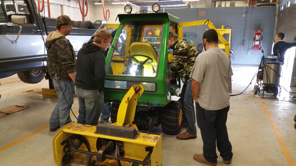 Students working on the snow plow in auto class.