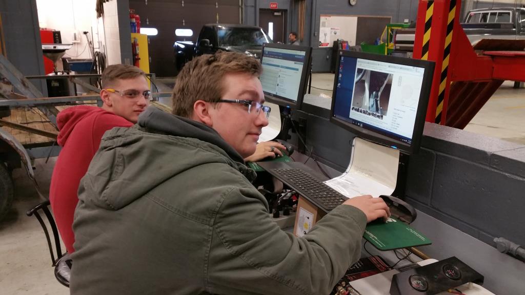 Students working on the computer to find parts in diesel class.