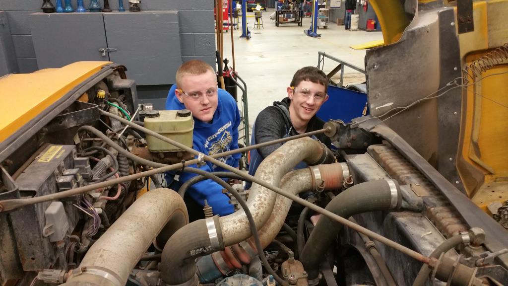 Students working on a bus in diesel class.