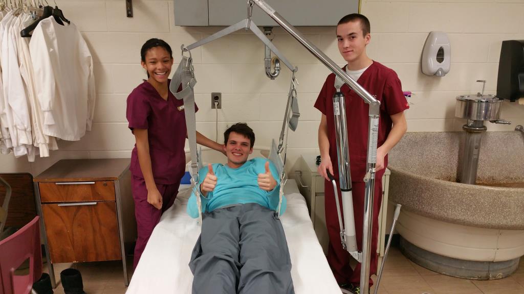 Health students practicing patient transfer.