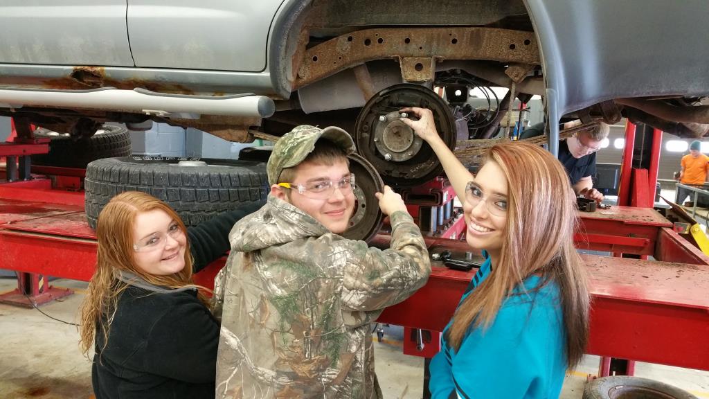 Students removing a tire in diesel class.