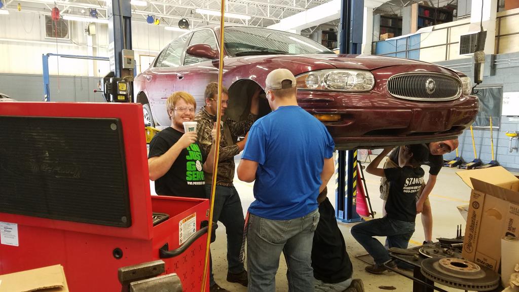 Students working on a car in auto class.