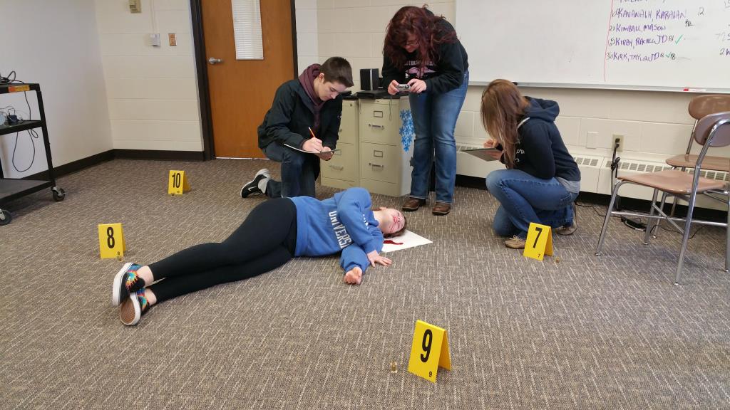Students working a "crime scene" in their classroom.