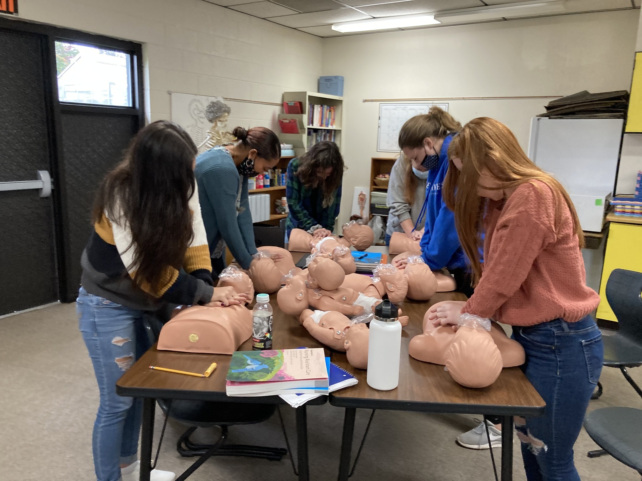 Health students learning CPR in class.