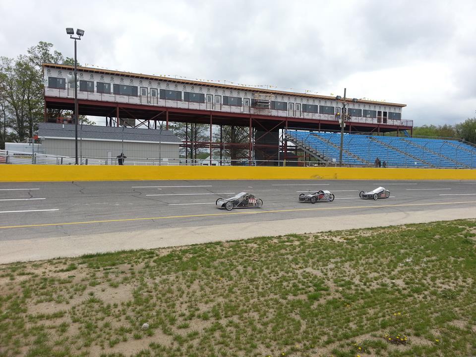 students on the race track in their electric cars.