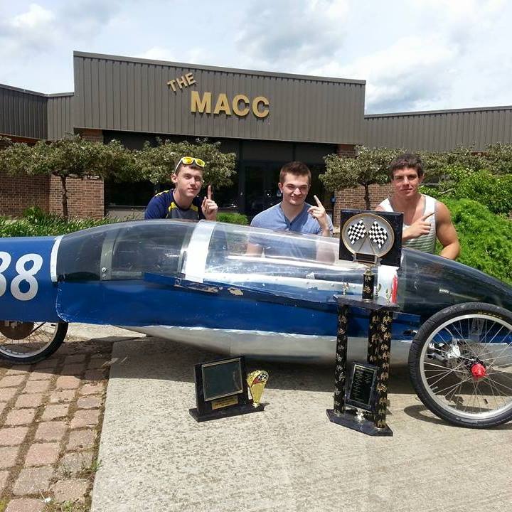 Students with their electric car and trophies.