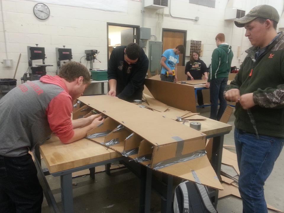 Students working on their cardboard boat for the race.