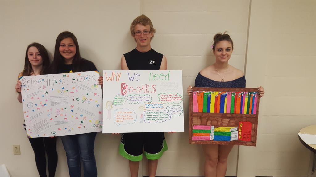 English students with posters that they made about the importance of books.