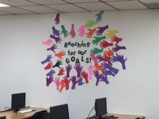 Reaching for our goals hands in English class.