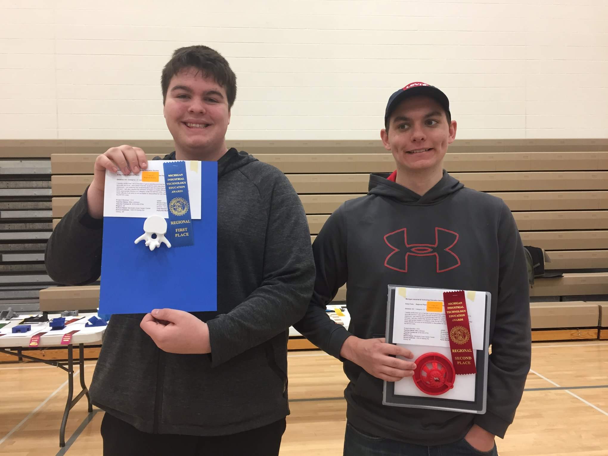 Two CAD students displaying their prizes at the MITES competition.