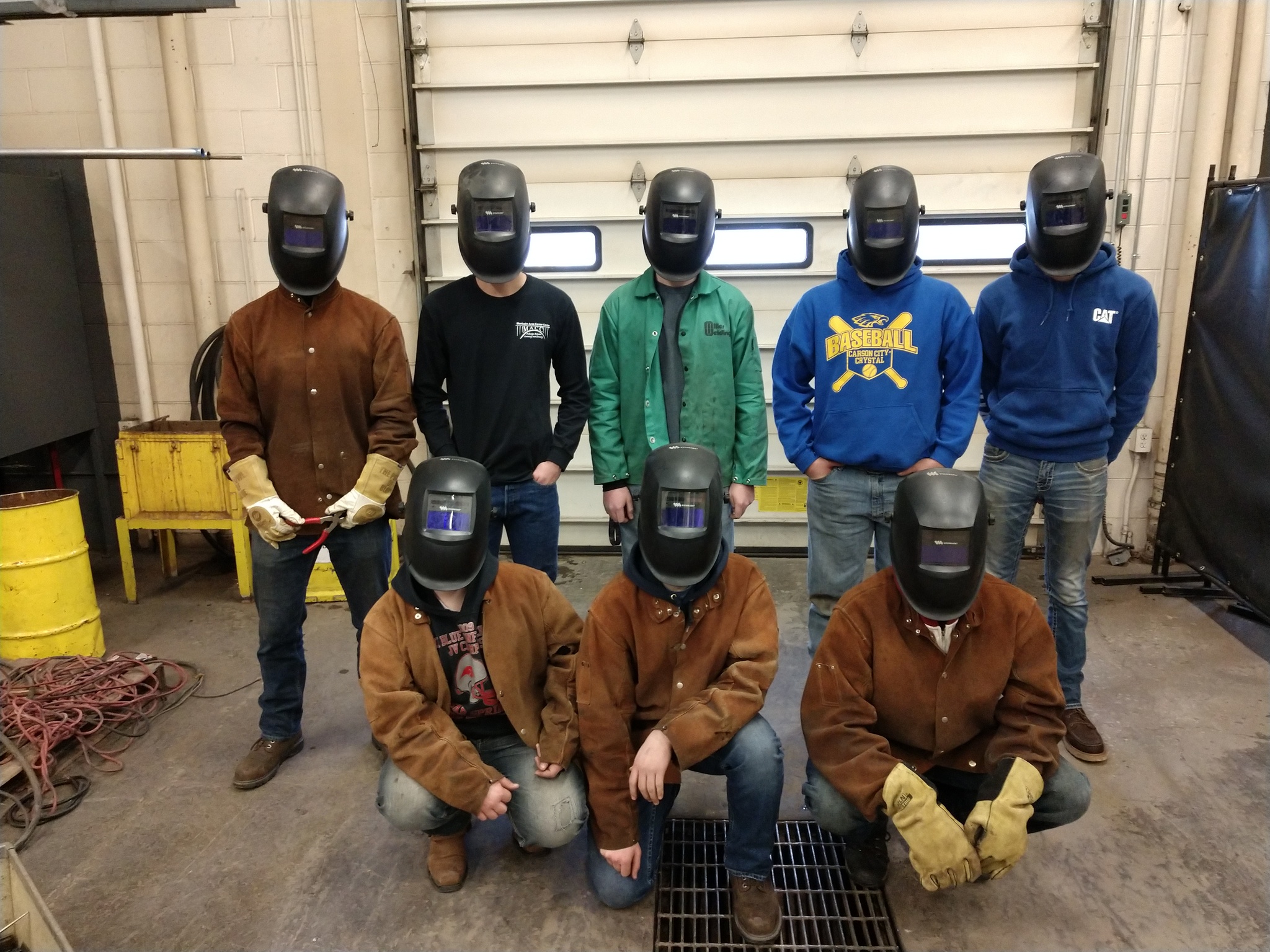 A picture of students wearing new self-darkening welding hoods donated by local business partners.
