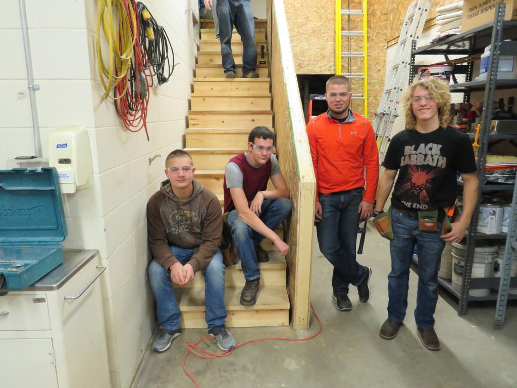 Construction students build stairs in maintenance.