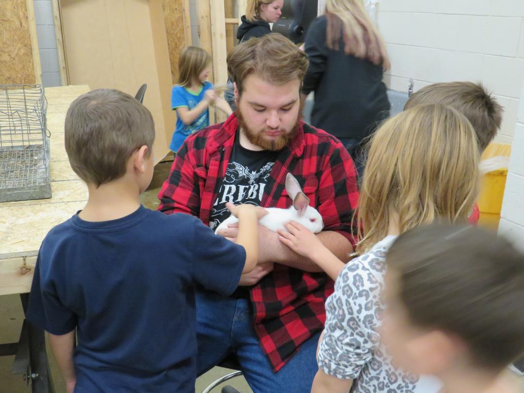 Plant and animal science students bring animals for the second graders to visit with.