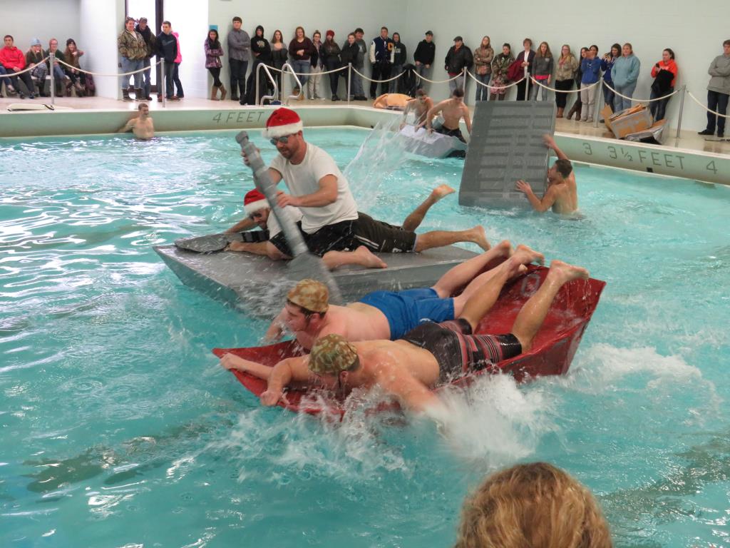 Staff and students participating in the cardboard boat race.