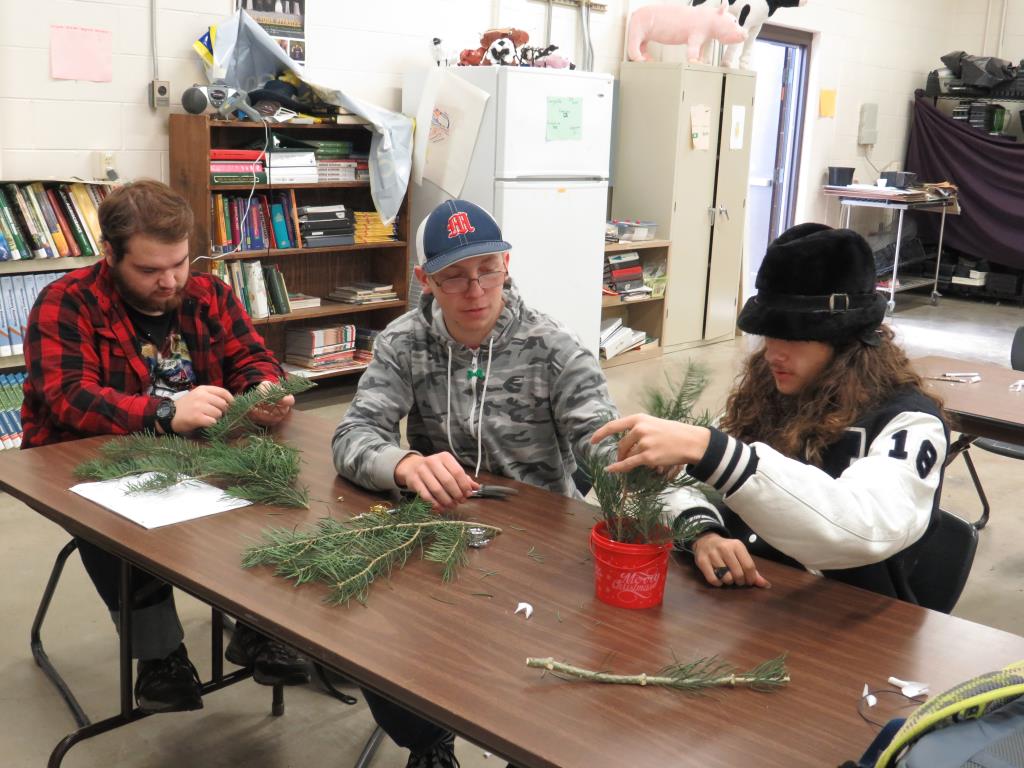 Plant and animal science class works on the centerpieces for the pancake breakfast.
