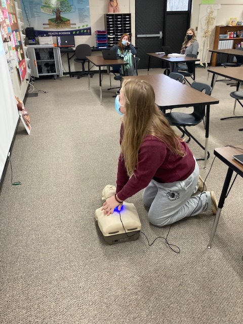 A health student practicing CPR.