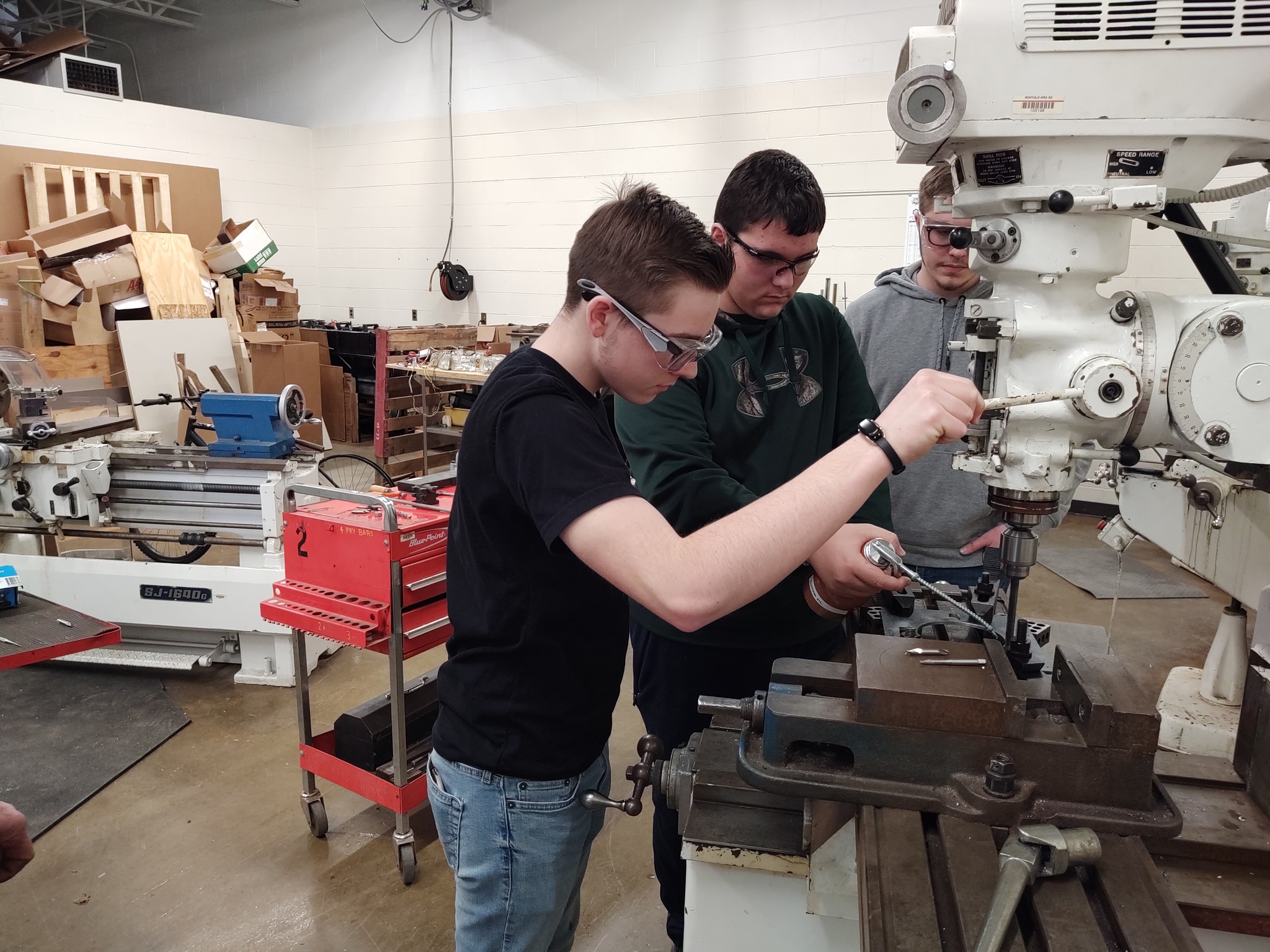Students working on machining parts.