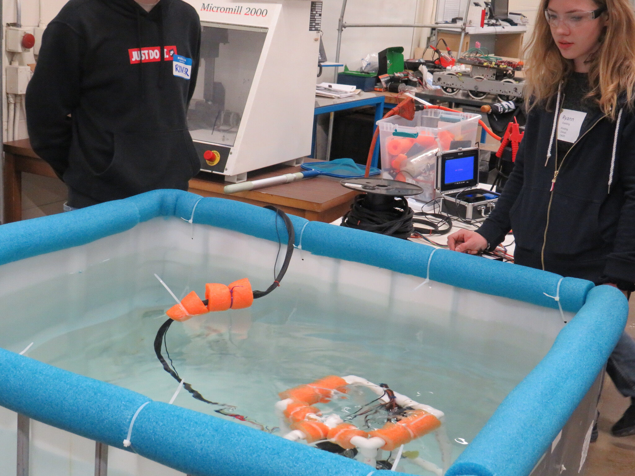 Students working with an underwater robot.
