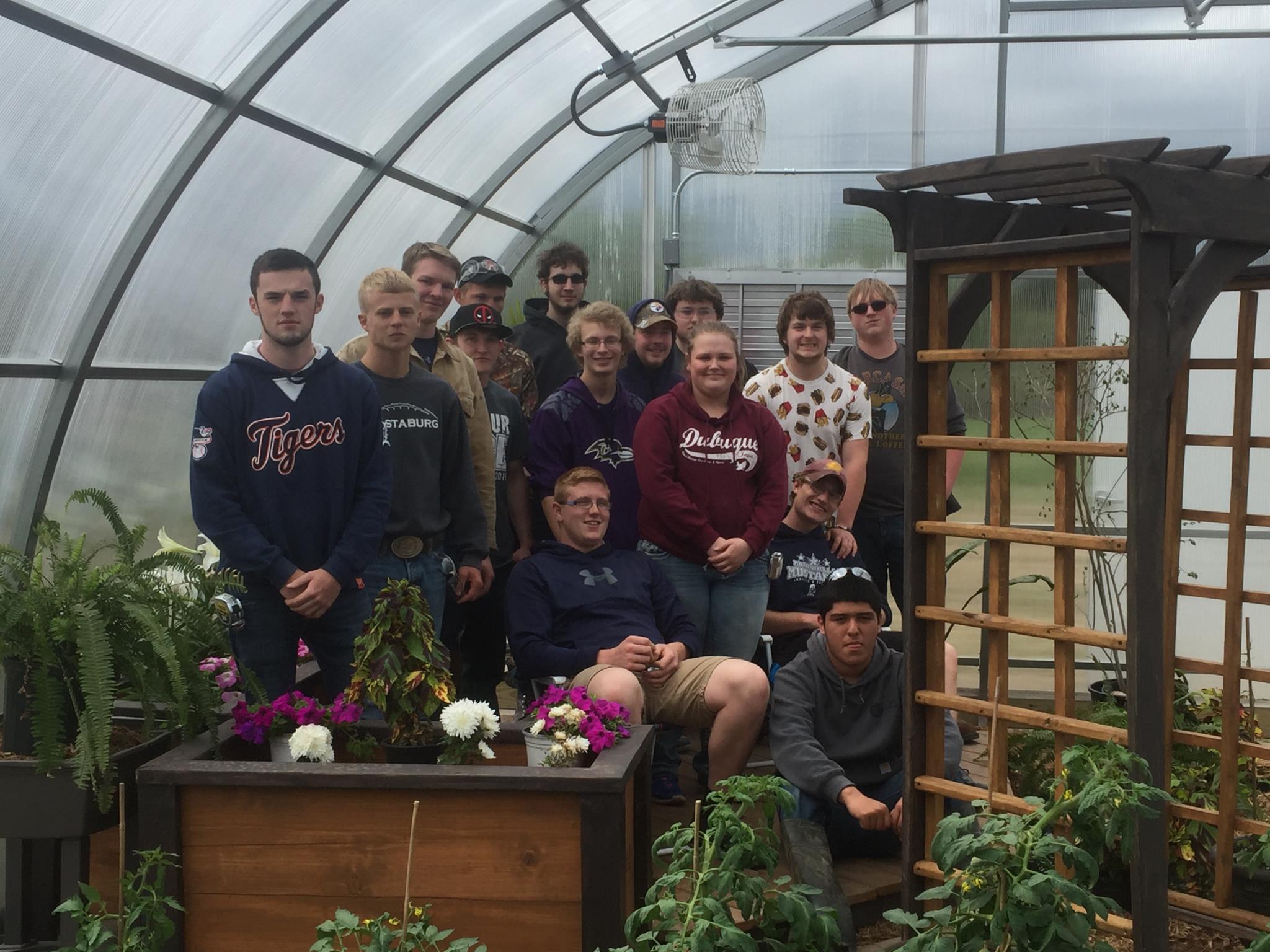 Construction students with the arbor and planter boxes they built for the MCC green house.